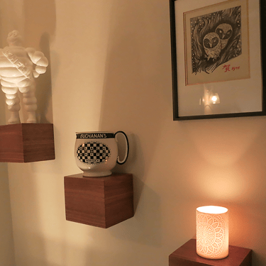A photo or ornaments on wooden shelving