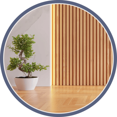 Bonsai on wood floor, beside slatted wood wall and lighting.