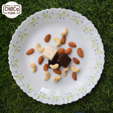 a plate with nuts and nuts on it with chocolates by chocoflare