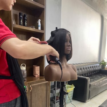 Stylist finishing a Vietnamese human hair bob wig at Vietsilkhair.