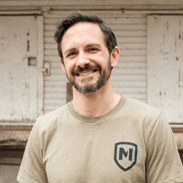 white man smiling at camera