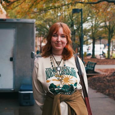 Young redheaded college woman smiling at camera.