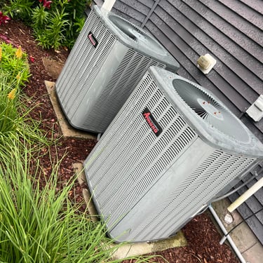 two hvac units sitting outside