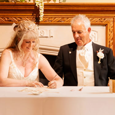 Couple Signing Certificate At Their Tying The Knot Ceremony