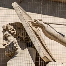 Close up on the hand of History's statue.