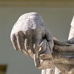 Close up on the hand of the Peace fountain's statue.