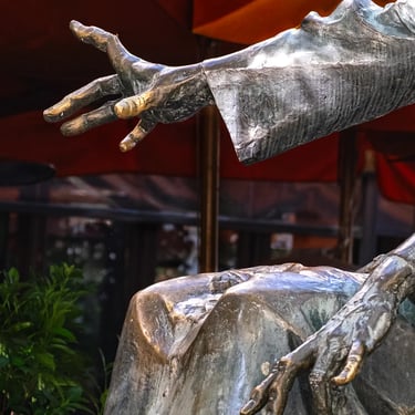 Both sculpted hands in a dynamic pose, reminiscent of playing piano with intensity.
