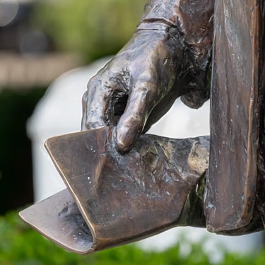 Hand of the statue holding speech papers, evoking his spontaneous Budapest address.