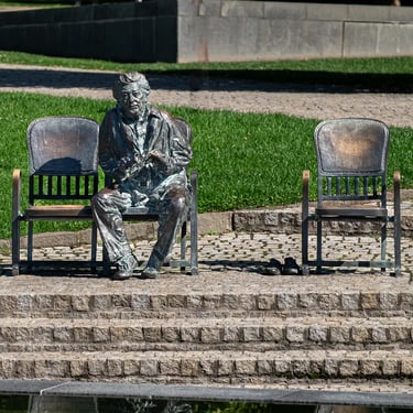 Front view of Hilda Gobbi by the water, her reflection suggesting quiet introspection.