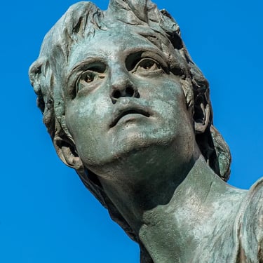 Close-up of Piroska Rozgonyi’s head with blue sky and Corinthian column behind.
