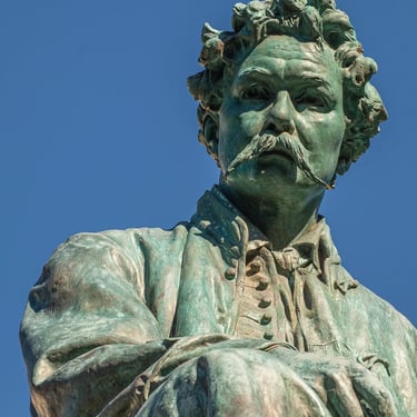 Upper-body view of János Arany’s statue, the poet gazing outward in reflection.