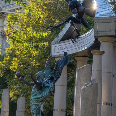 Side view of full memorial, angel and eagle facing off in frozen confrontation.