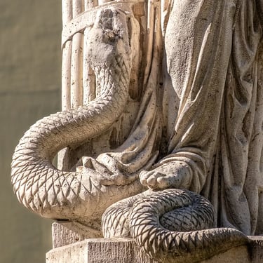 Detailed view of the snake under the statue’s foot, symbolizing evil overcome.