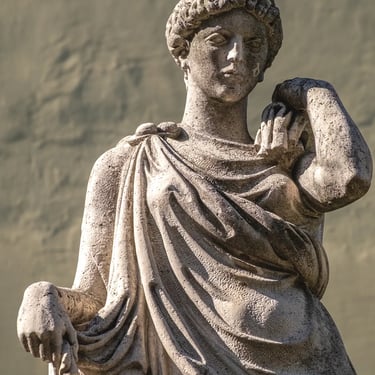 Upper body of the Peace statue with head and outstretched hand, serene expression.