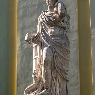 Frontal view of the entire Peace statue on the fountain, capturing wings and posture.