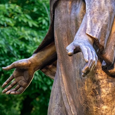 Both hands of Saint Barbara, open in a gesture of protection and strength.