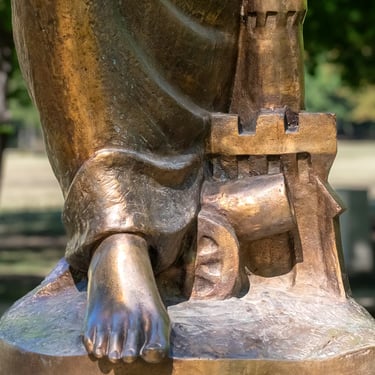 Foot of Saint Barbara’s statue, firmly planted with detailed sculpted texture.