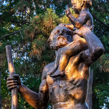 Upper body of Saint Christopher holding Jesus, representing care for travelers.