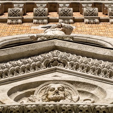 Full statue of St. Francis on the main facade, in architectural context.
