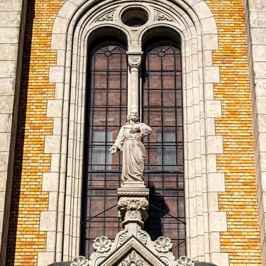 Dramatic low angle with only the hands visible, Christ looking out from the backdrop.