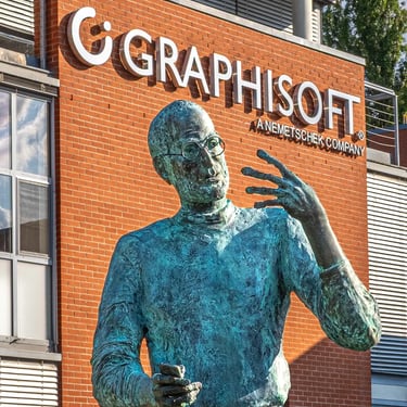 Upper body of Steve Jobs statue with head and hands, Graphisoft HQ in the background.