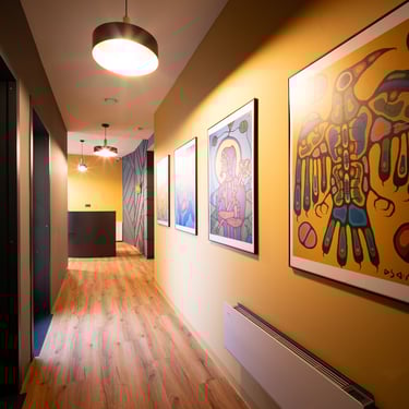 Art-lined corridor leading to treatment rooms at DentalX dental clinic in Prague