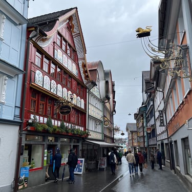 Looking down a street in Appenzell in Switzerland at colorful buildings and store fronts