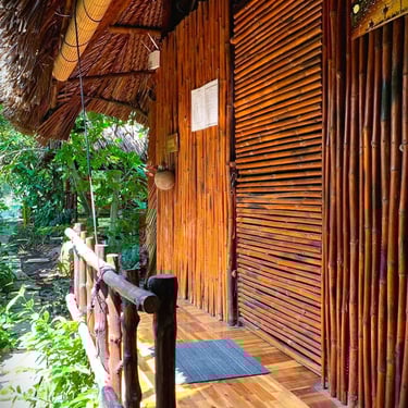 Spacious twin-bed room with large windows overlooking the tropical vegetable garden.