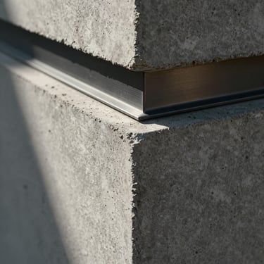 Close-up of raw architectural concrete block meeting a polished dark metal trim, dramatic side lighting, sharp focus on material textures.