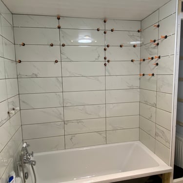 bathroom wall tiled using tile levelling spacers