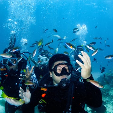 scuba diver students enjoying the variety of fishes in Lapu-lapu