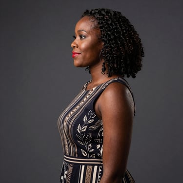Portrait of a smiling professional woman in a modern office setting.