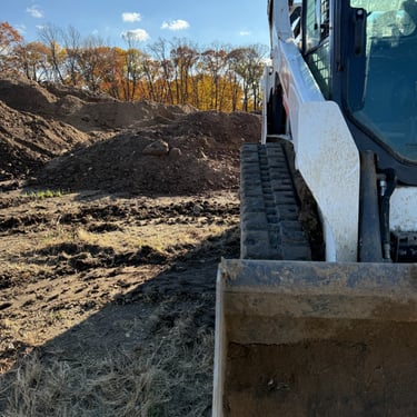skid-steer-with-dirt-pile