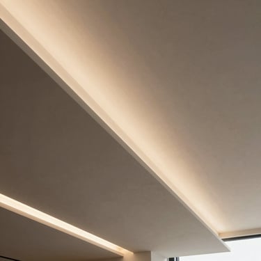 Architectural low-angle shot of a minimalist gypsum board ceiling with integrated warm LED lighting channels, clean sharp edges.