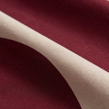Macro close-up of premium designer fabric with subtle contemporary patterns, soft studio lighting