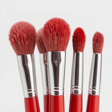 Angled blush and contour makeup brushes, close-up of soft red-tipped bristles
