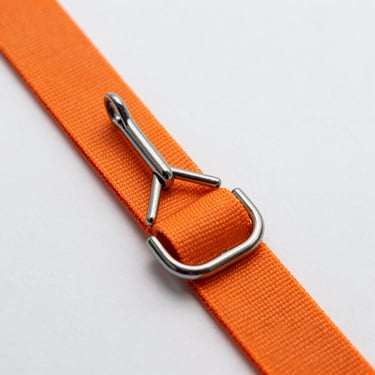 Close-up of a double-finger steel J-hook attached to a high-density orange polyester strap on a white background.