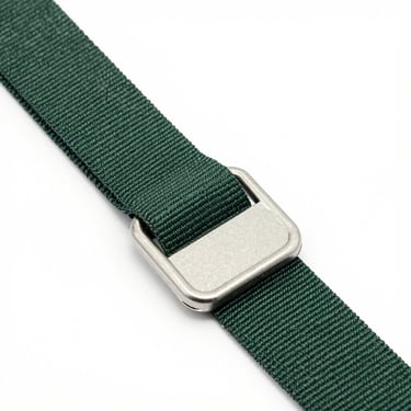 Close-up of a custom-length green polyester securing strap with heavy steel hardware on a white background.
