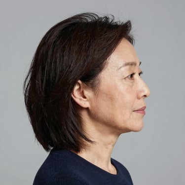 A happy customer smiling while reviewing a project on a laptop.