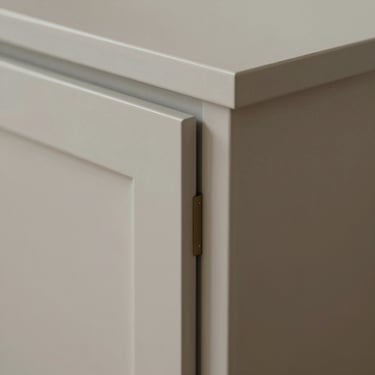 Detailed view of a standard shaker cabinet door, focusing on the crisp joints and smooth factory finish.