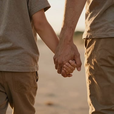 Close-up of a parent and child holding hands while walking outdoors, soft golden hour light, warm earth tones, candid unposed moment