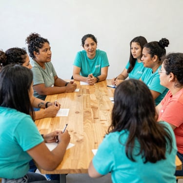 Diverse group of local organizers collaborating around a wooden table in a bright community space, candid.