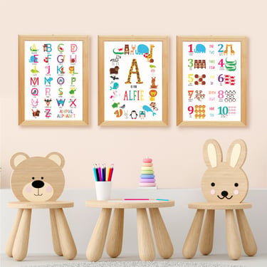 Set of three personalised alphabet and educational nursery prints displayed above a children's table