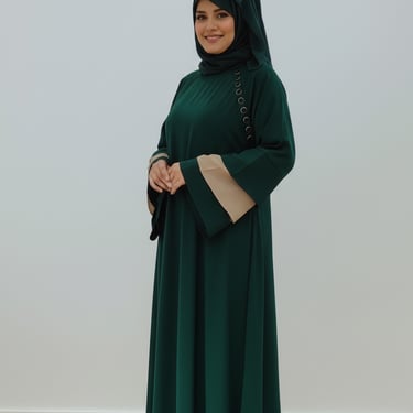 a woman in a green dress standing in a room