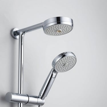 Detailed shot of a multi-function shower head and chrome shower robot system, bright studio lighting