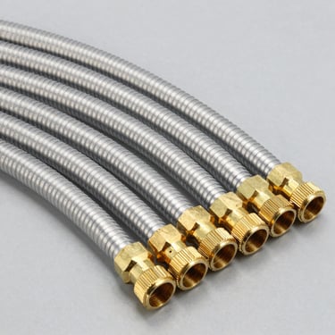 Organized rows of durable flexible plumbing hoses and brass connection fittings
