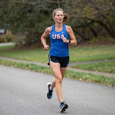 Portrait of a smiling woman over 40 with warm natural lighting, radiating calm confidence.