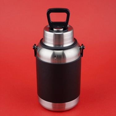 Isolated product shot of a heavy-duty insulated beverage bucket with built-in bottle opener, bright high-key lighting, vibrant red backdrop, sharp focus