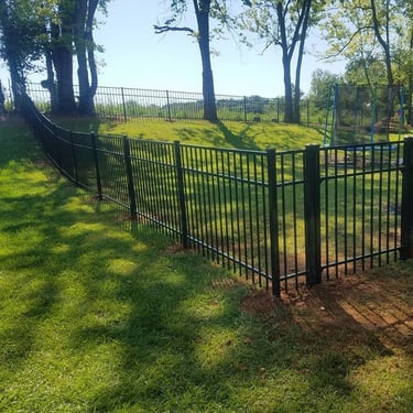 Black aluminum residential fence installed along a front yard property line