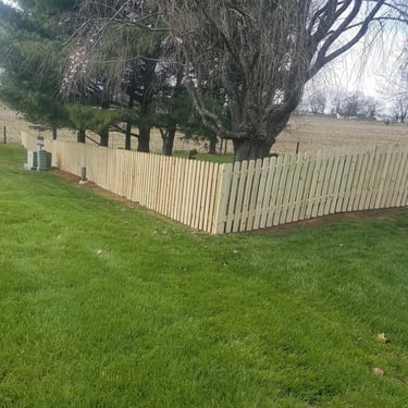 natural wood picket fence on residential property